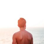 Gay man looking out at the ocean at a Costa Rica gay resort near San Jose