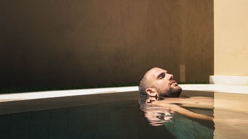 Man enjoying the pool after the steam room